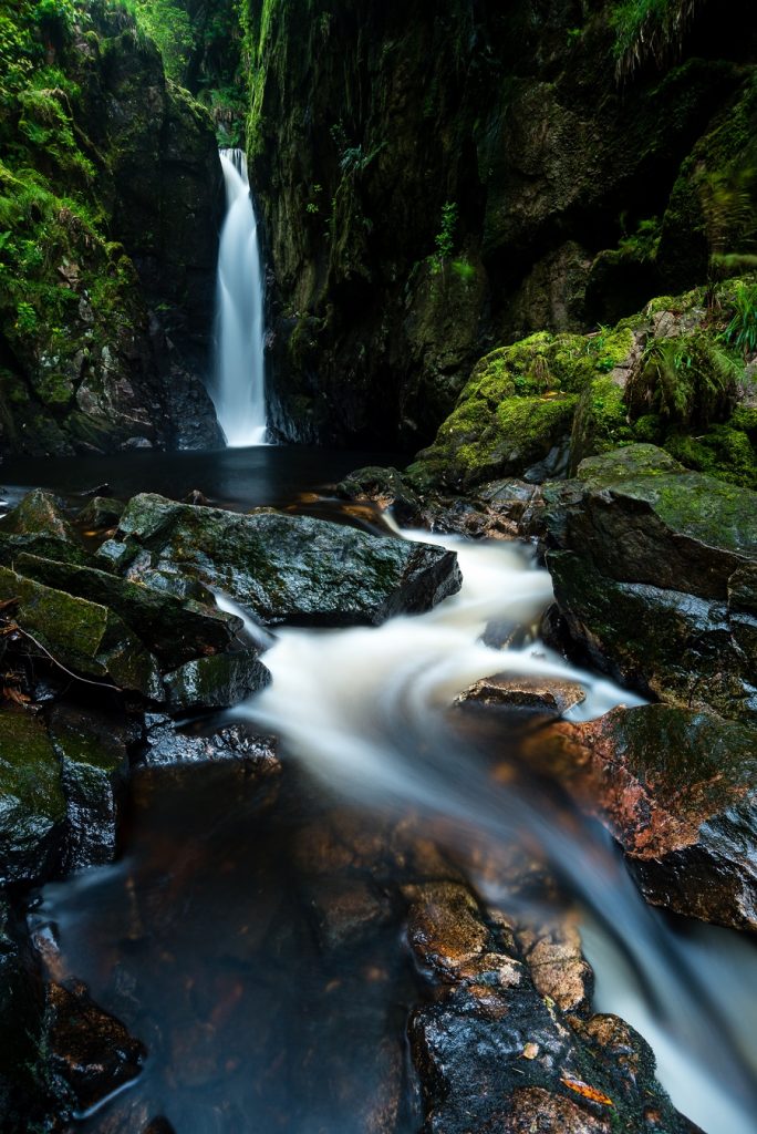 Here I used the technique of getting down close to the water to create a perfect leading line up to the waterfall, but using a polarising filter also revealed the gorgeous colours in the underlying rocks.